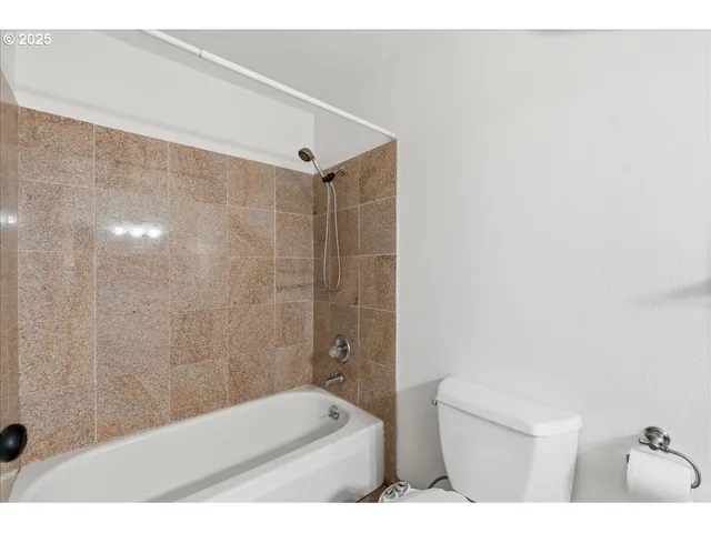 a bathroom with a shower and a toilet