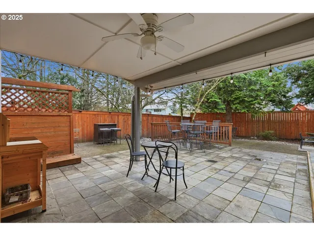 a view of a patio with a table and chairs under an umbrella