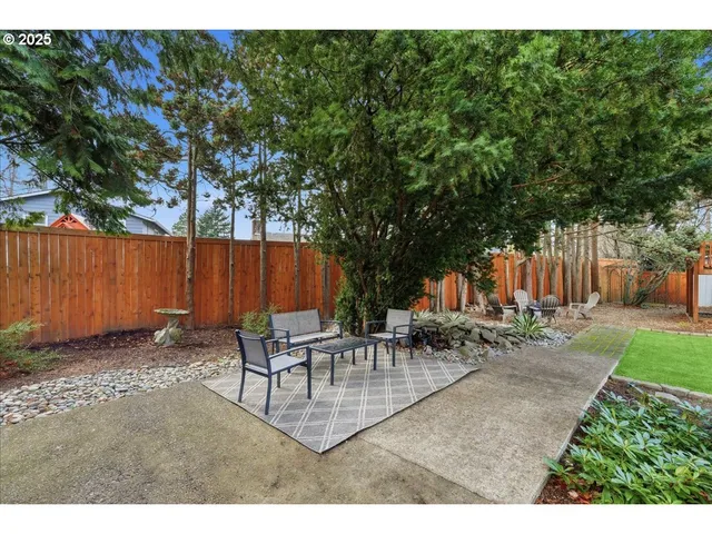 a backyard of a house with table and chairs