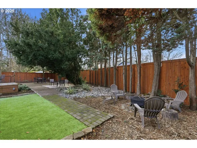 a backyard of a house with table and chairs