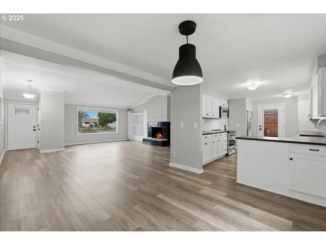 a view of a kitchen with a sink stainless steel appliances and cabinets