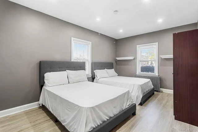 a bedroom with double bed and a window