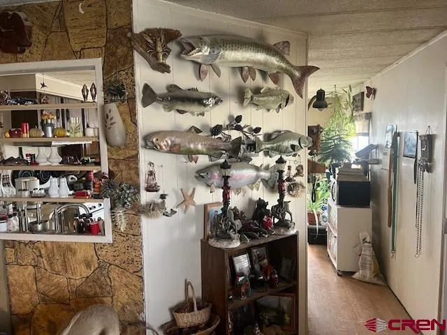 a room with lots of white furniture and a flat screen tv