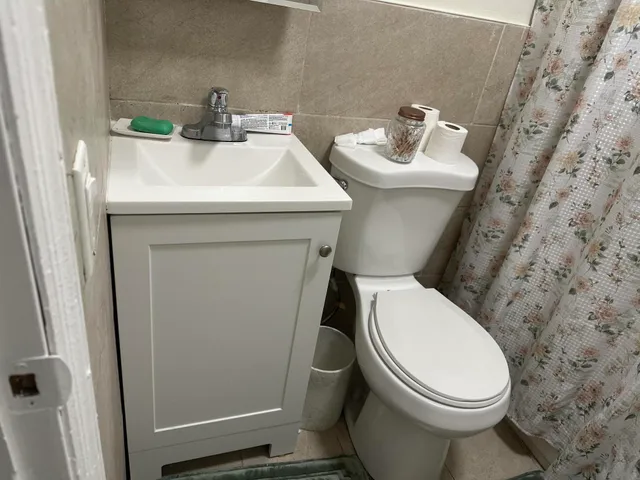 a bathroom with a sink a toilet and a mirror