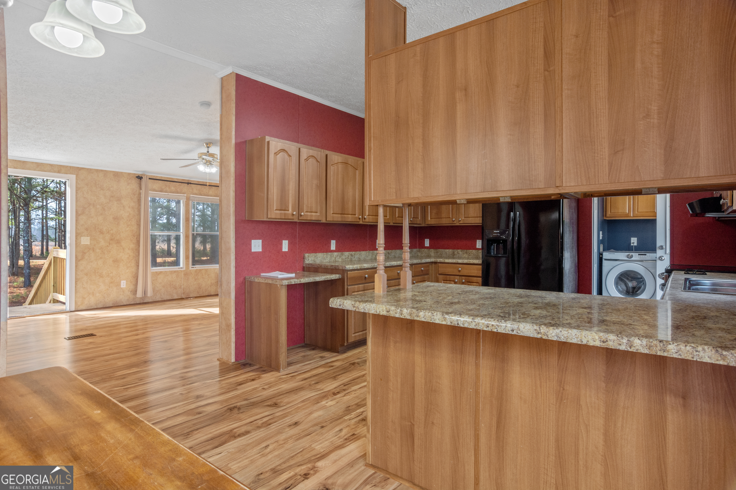 907 Sheppard Road Tennille, GA 31089 - Photo 13 of 54 a kitchen with stainless steel appliances granite countertop a sink counter space and cabinets