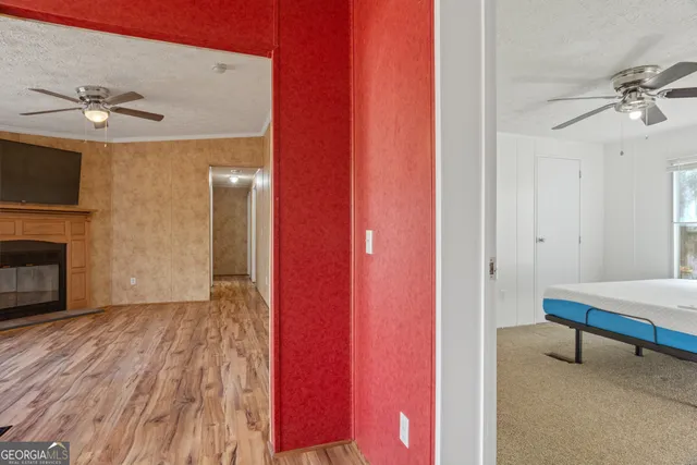 a view of room with hardwood floor and ceiling fan