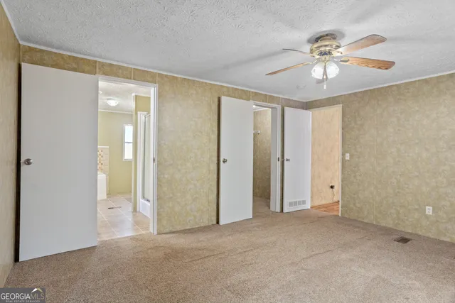 a bathroom with a granite countertop sink a mirror and a toilet