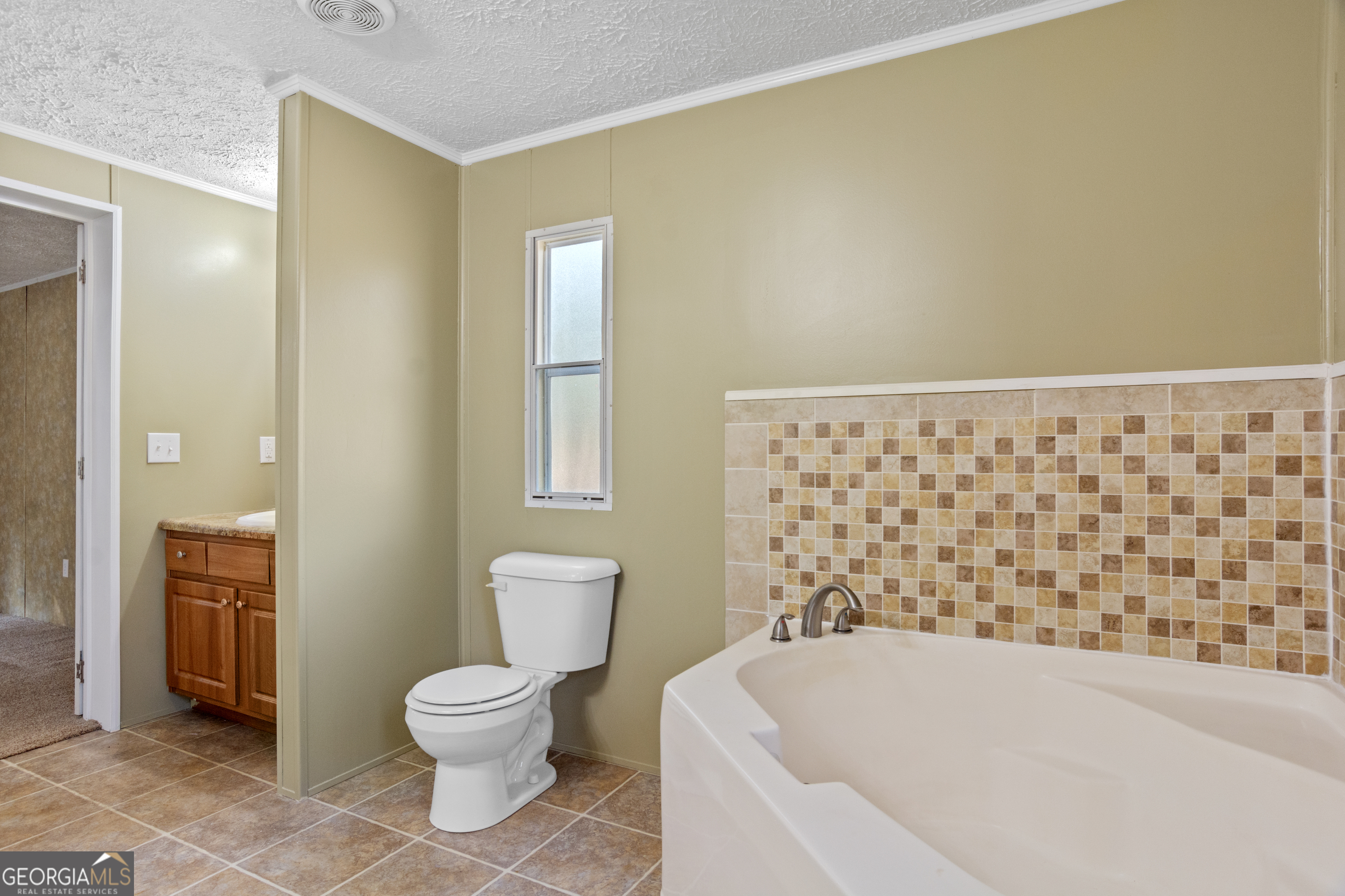 907 Sheppard Road Tennille, GA 31089 - Photo 24 of 54 a bathroom with a toilet and a shower