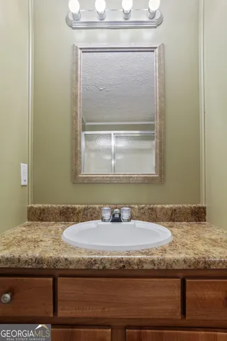 an empty room with a chandelier fan and closet area