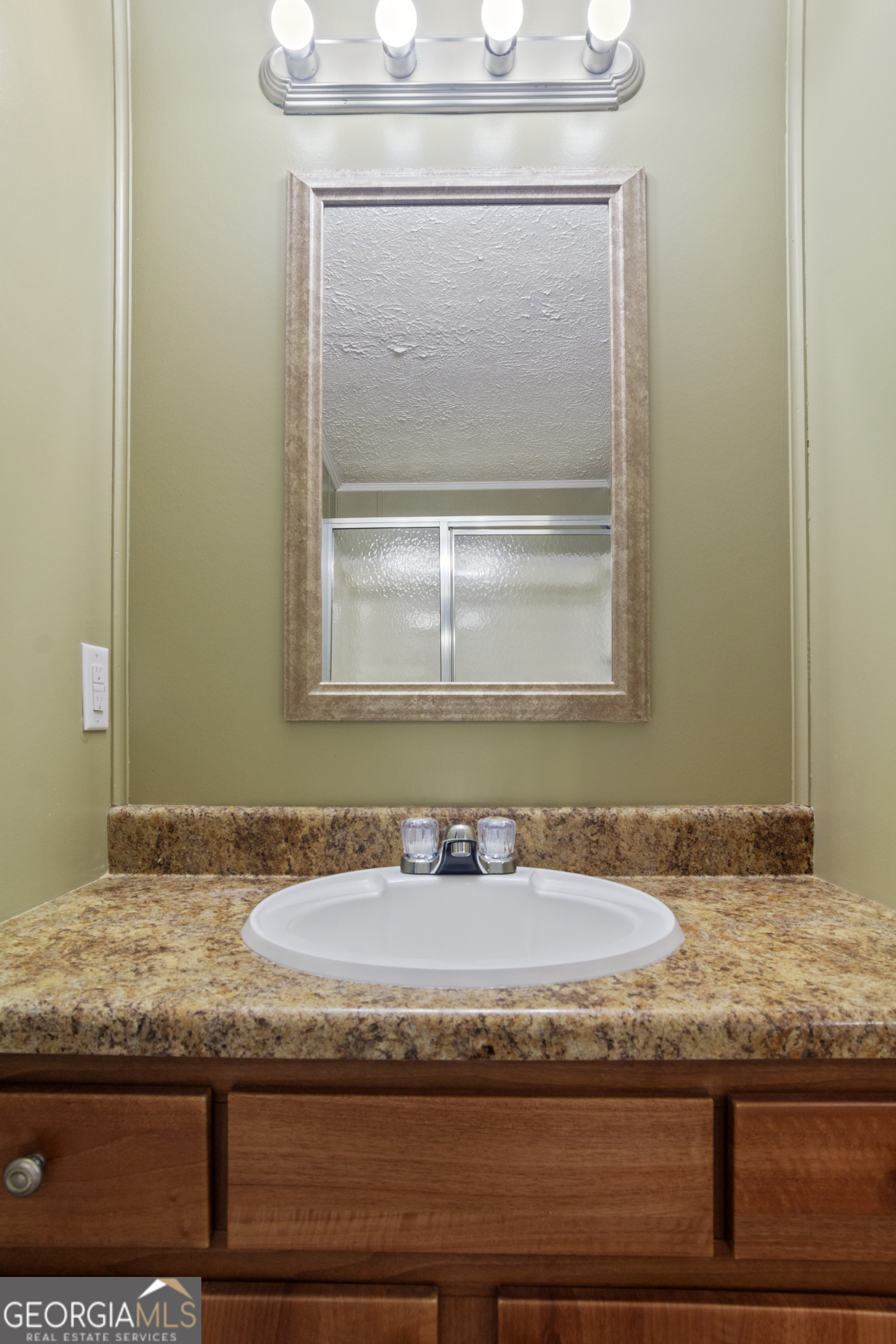 907 Sheppard Road Tennille, GA 31089 - Photo 28 of 54 a bathroom with a granite countertop sink and a mirror