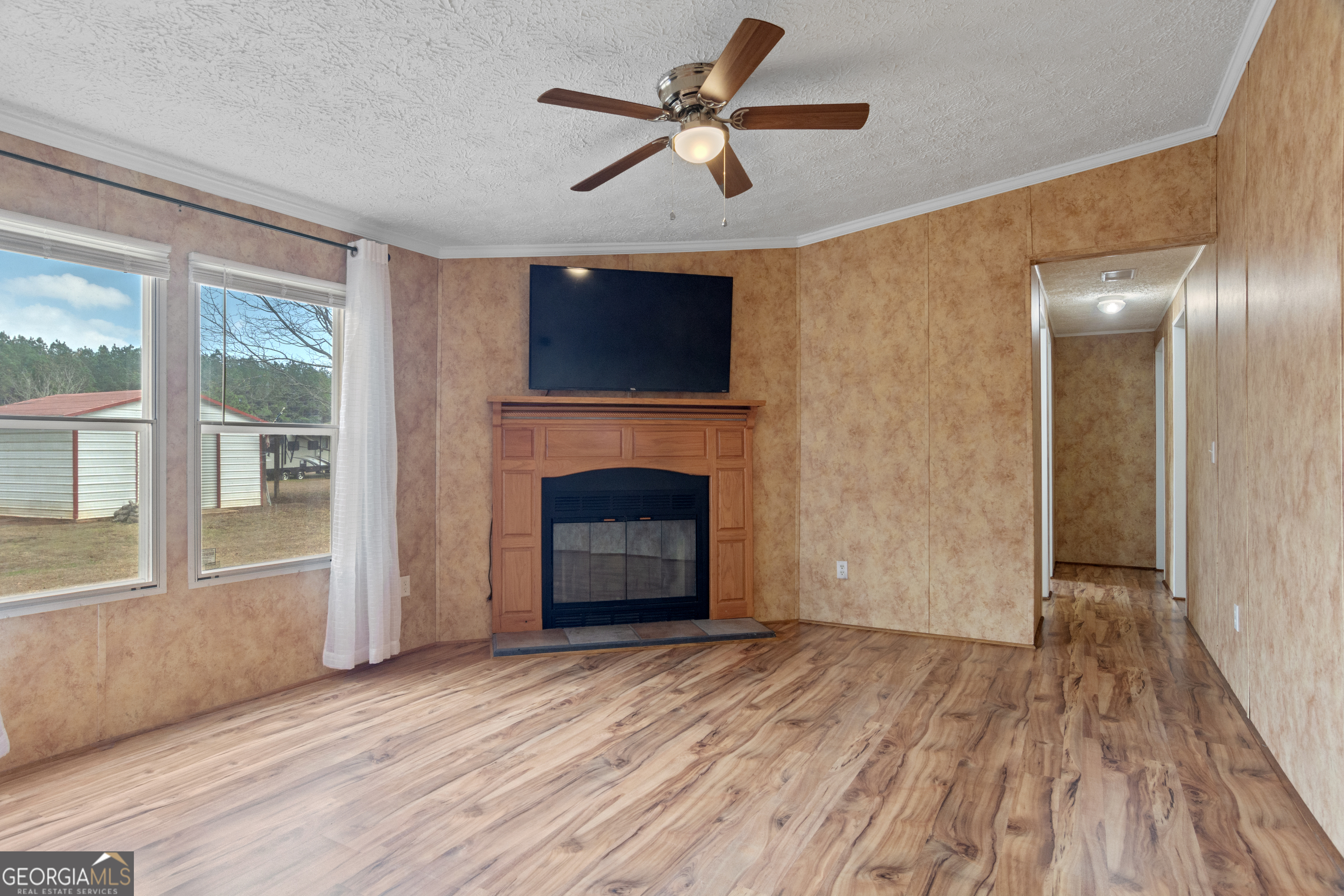 907 Sheppard Road Tennille, GA 31089 - Photo 30 of 54 a view of empty room with wooden floor and fan