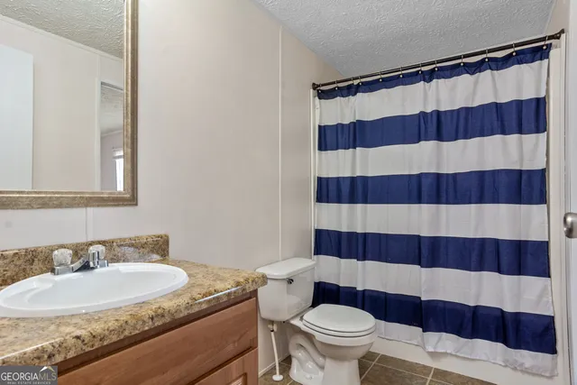 a bathroom with a granite countertop sink and mirror