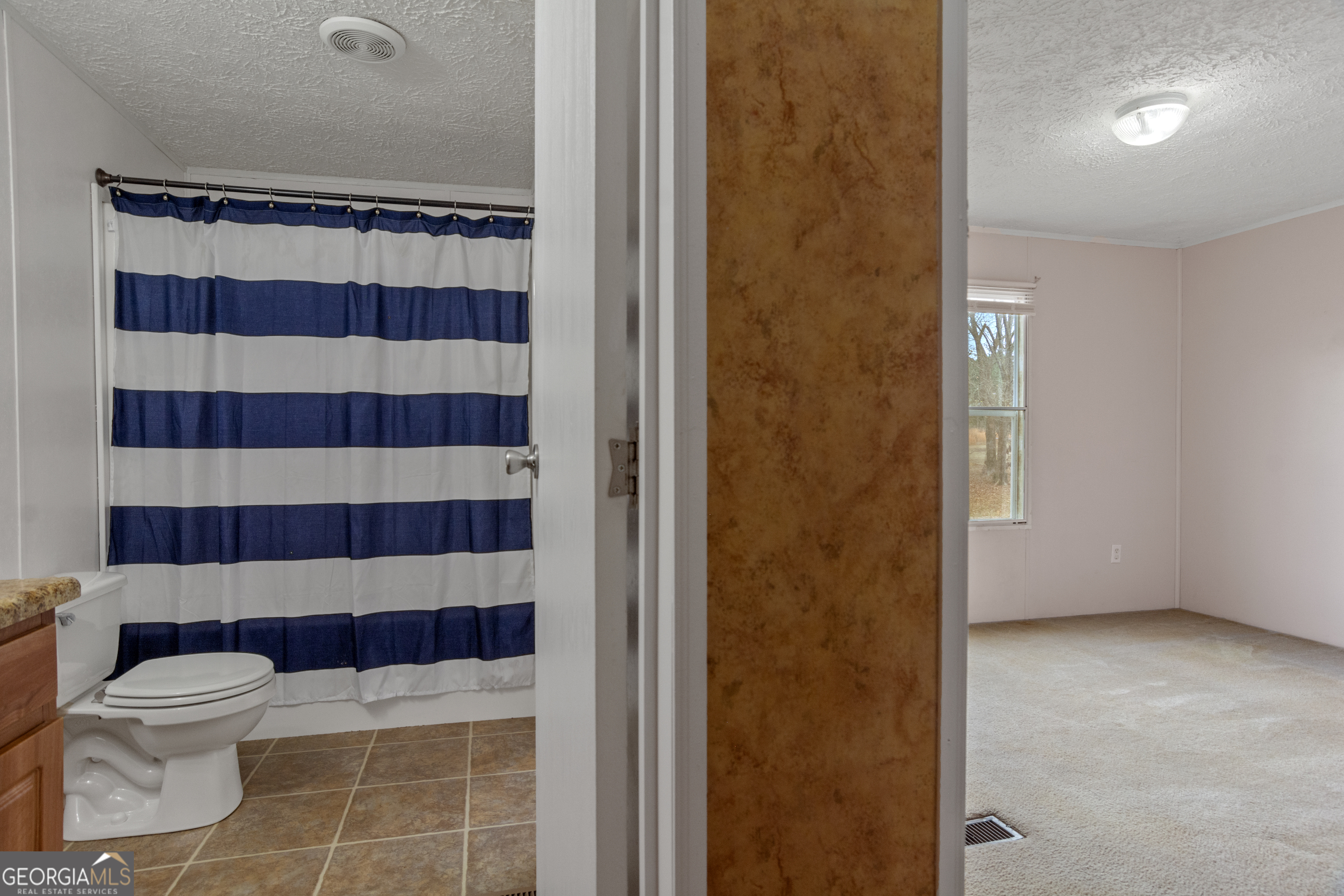 907 Sheppard Road Tennille, GA 31089 - Photo 34 of 54 a bathroom with a toilet and a shower