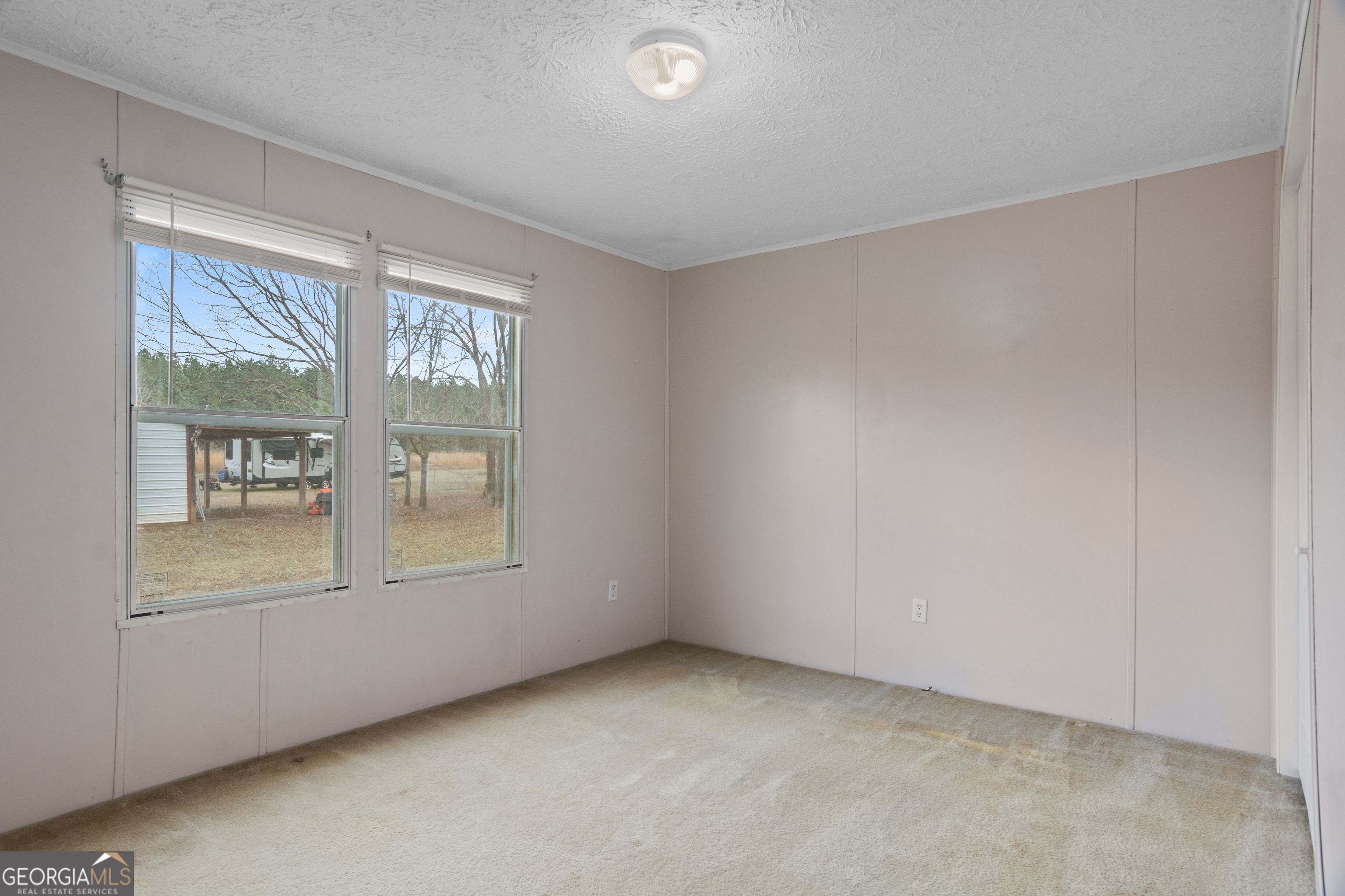 907 Sheppard Road Tennille, GA 31089 - Photo 35 of 54 an empty room with windows