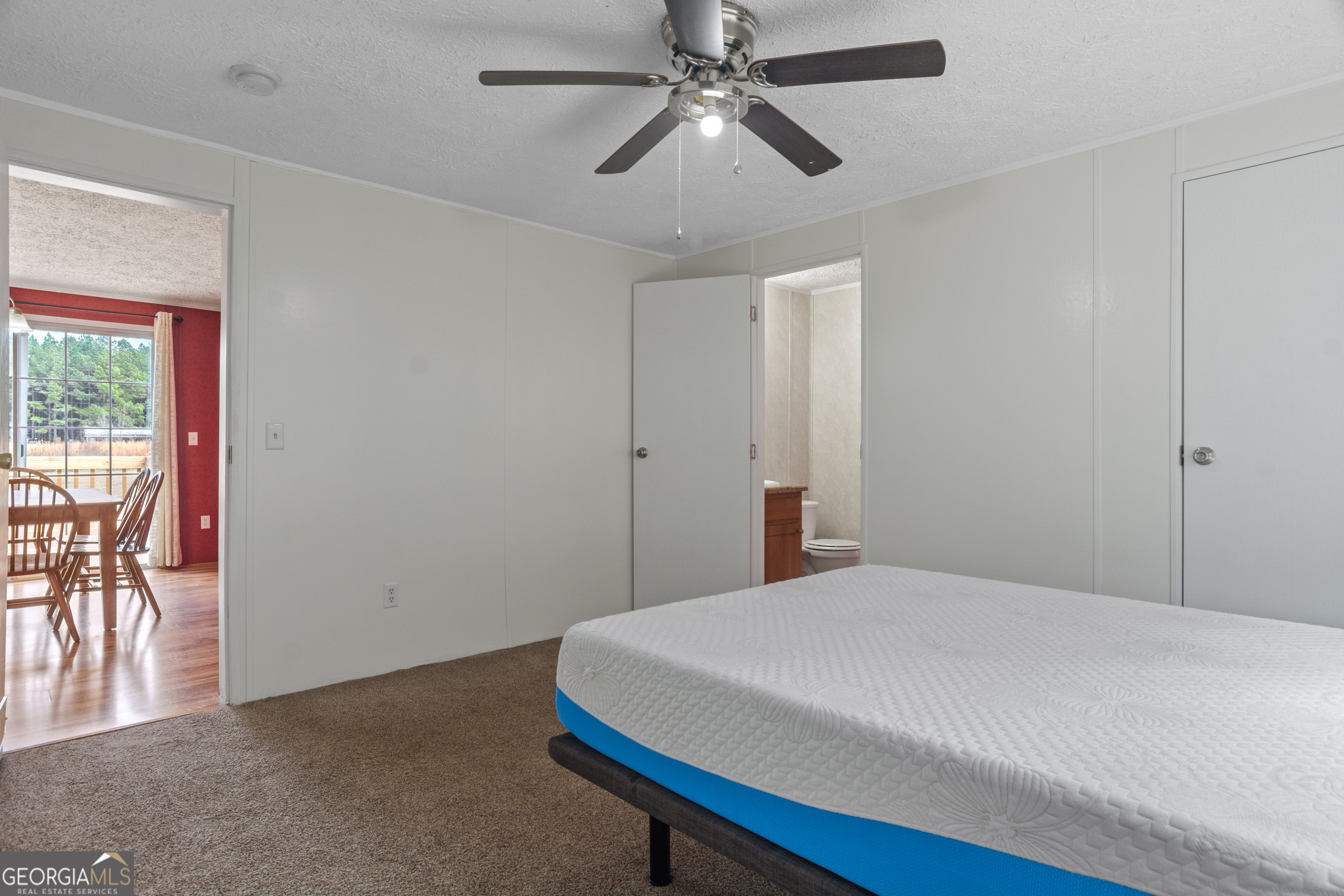 907 Sheppard Road Tennille, GA 31089 - Photo 42 of 54 a bedroom with a bed and a chandelier