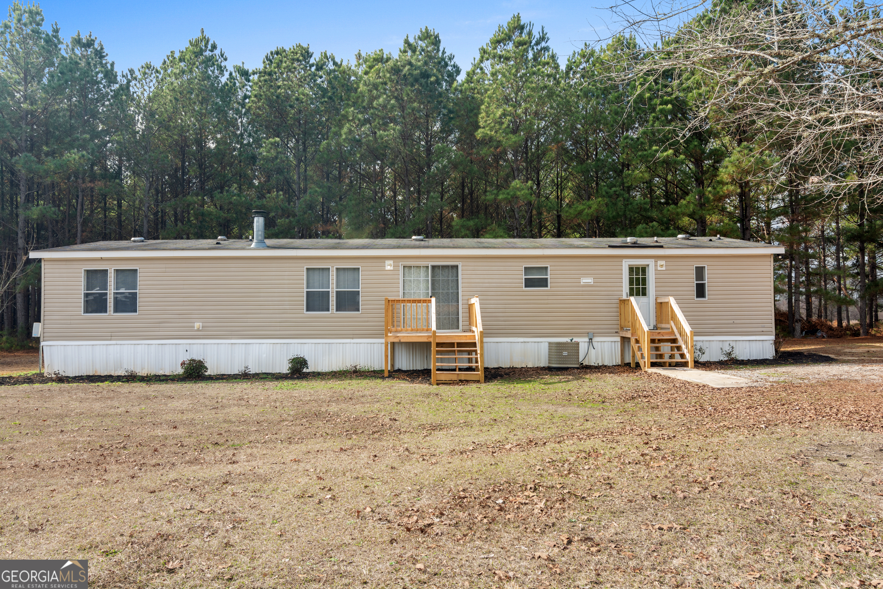 907 Sheppard Road Tennille, GA 31089 - Photo 5 of 54 a view of a house with backyard in front of it