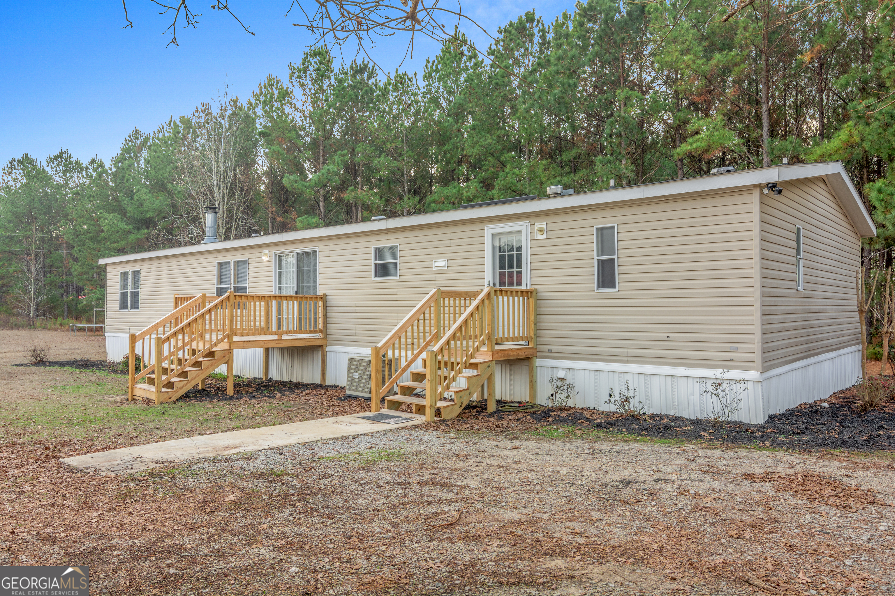 907 Sheppard Road Tennille, GA 31089 - Photo 6 of 54 a view of a house with a yard and wooden fence