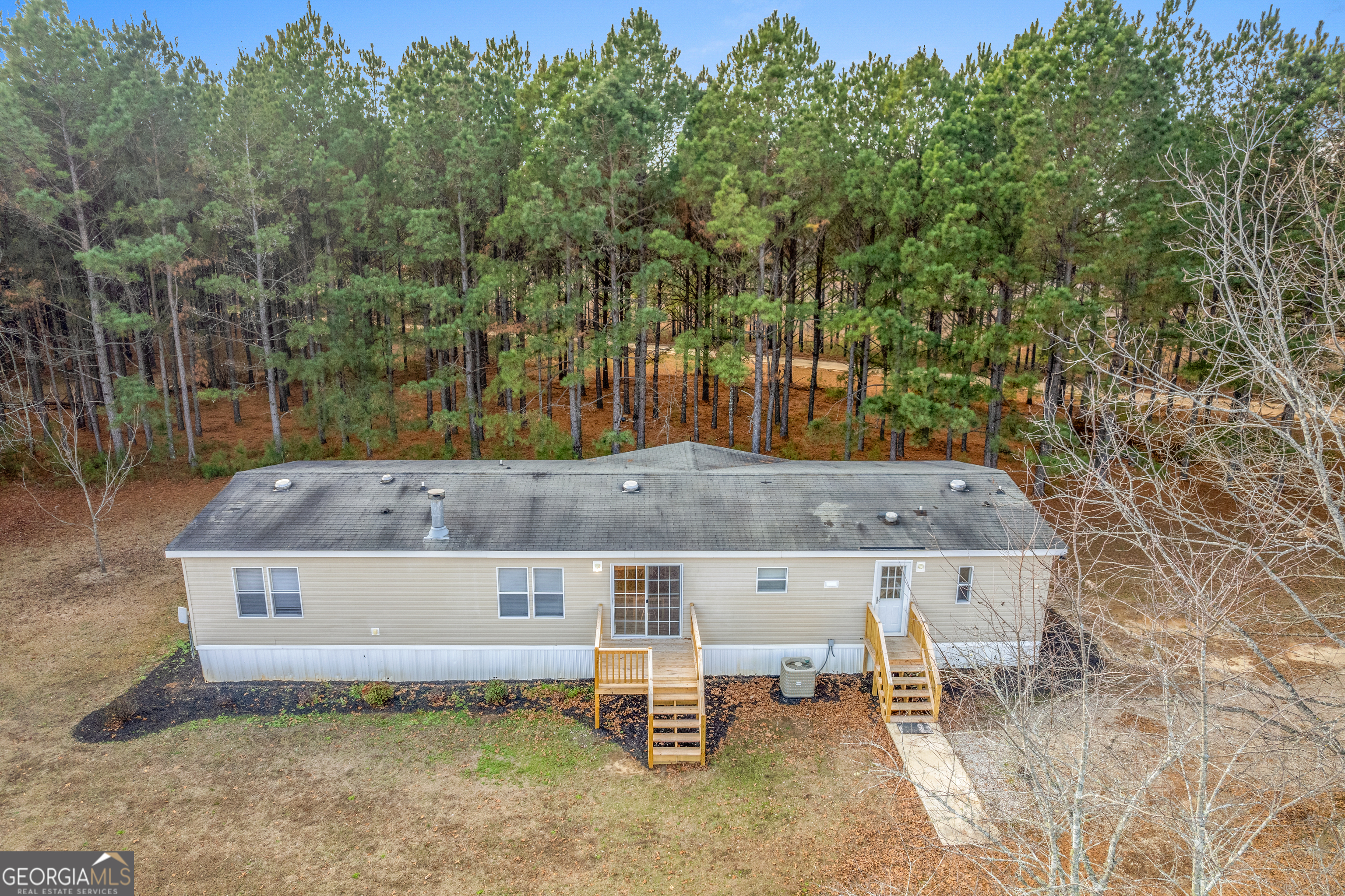 907 Sheppard Road Tennille, GA 31089 - Photo 7 of 54 a view of a terrace with a bench and trees