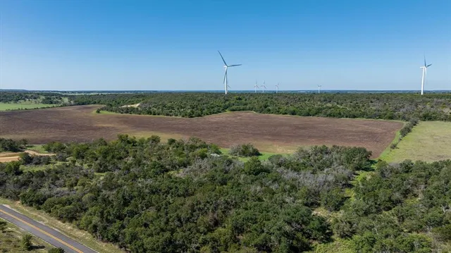 an aerial view of a field with wooden fence