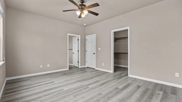 a view of an empty room with wooden floor