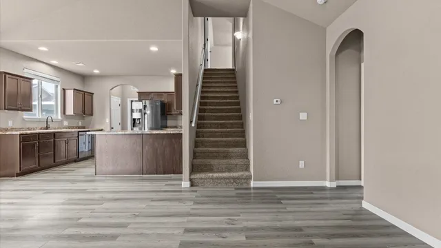 a view of kitchen with wooden floor and electronic appliances