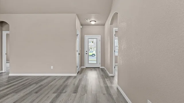 a view of a hallway with wooden floor