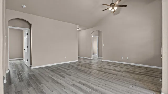 a view of an empty room with wooden floor