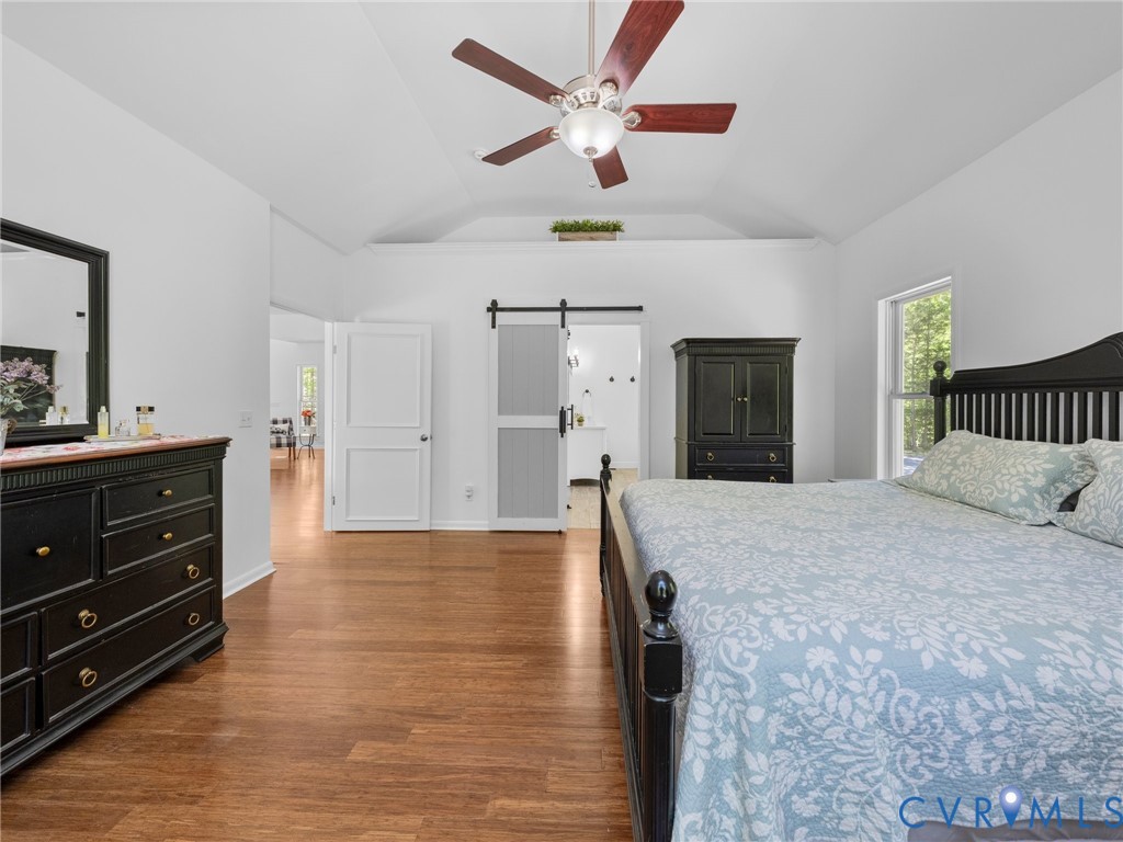 6126 Autumn Bluff Road Powhatan, VA 23139 - Photo 32 of 47 a spacious bedroom with a bed a dresser and a chandelier