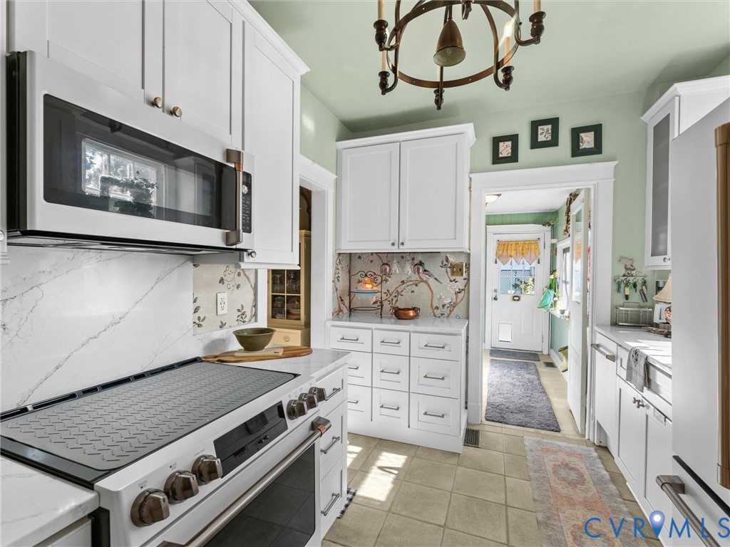 1812 Seddon Road Richmond, VA 23227 - Photo 19 of 56 Kitchen featuring white cabinetry, stone counterto