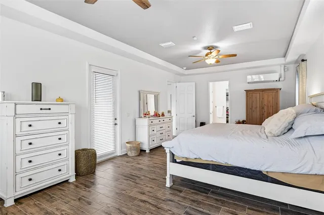 a bedroom with a balcony a bed and a large window