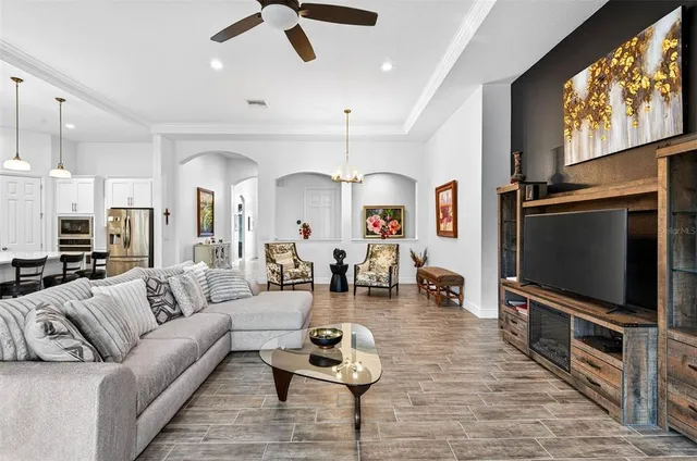 a living room with fireplace furniture and a flat screen tv