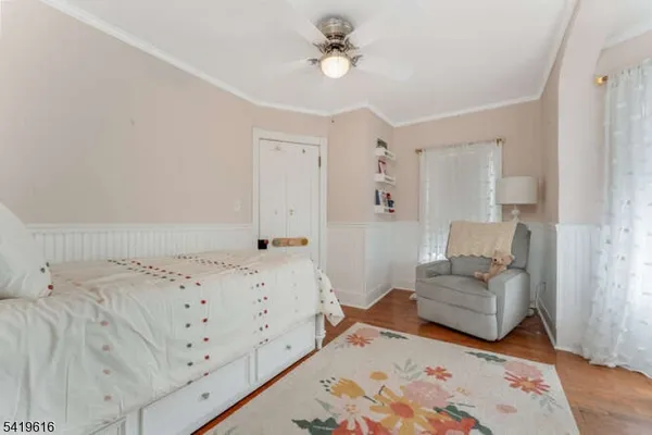a bedroom with furniture and a wooden floor