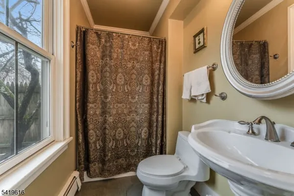 a white toilet sitting next to a bathroom sink