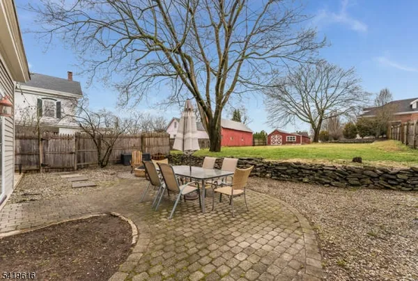 a view of a backyard with table and chairs and a fire pit