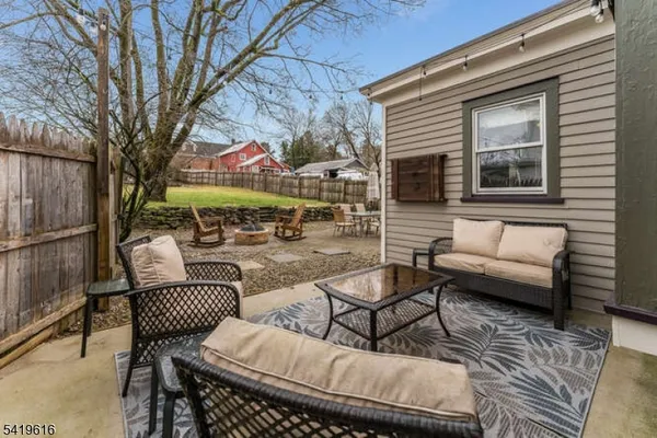 a balcony view with a couch and table and chairs