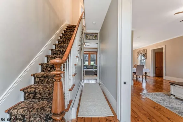 a view of an entryway with wooden floor