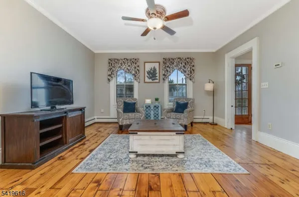 a living room with fireplace furniture and a flat screen tv