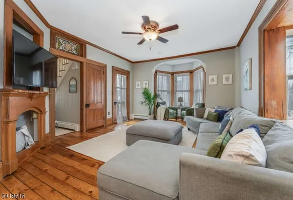 a living room with furniture a fireplace and a large window