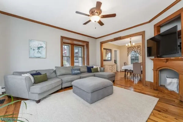 a living room with fireplace furniture and a flat screen tv