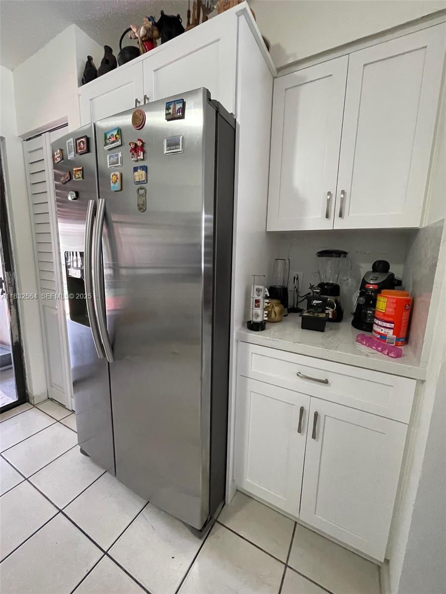 12057 Southwest 10th Street, Unit 202 Miami, FL 33184 - Photo 4 of 12 a kitchen with stainless steel appliances granite countertop a refrigerator and a sink
