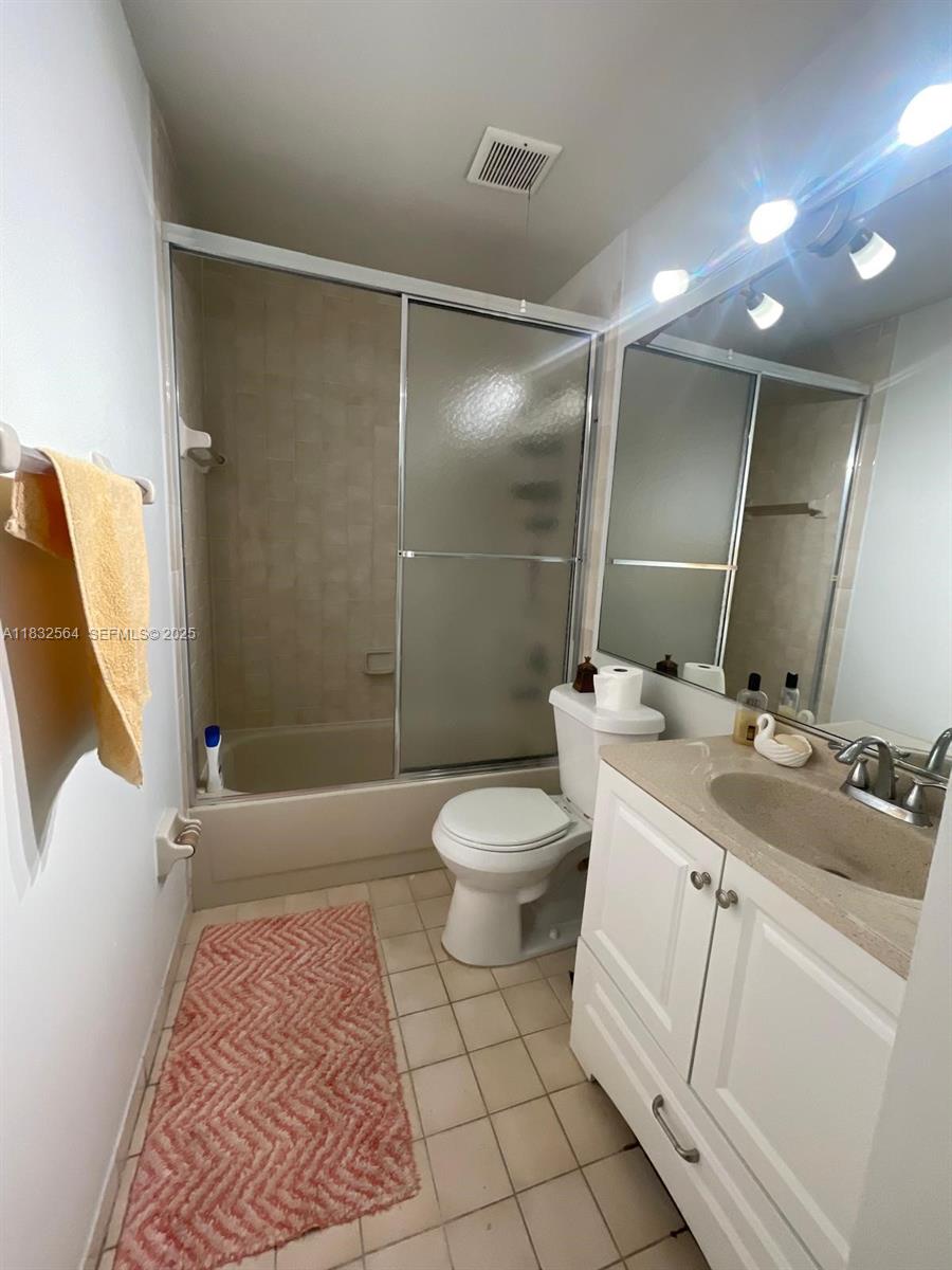 12057 Southwest 10th Street, Unit 202 Miami, FL 33184 - Photo 7 of 12 a bathroom with a sink toilet and shower