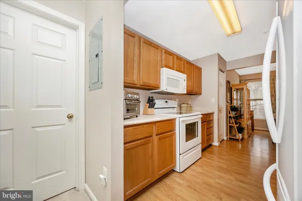 a large kitchen with stainless steel appliances granite countertop a stove a sink and a refrigerator