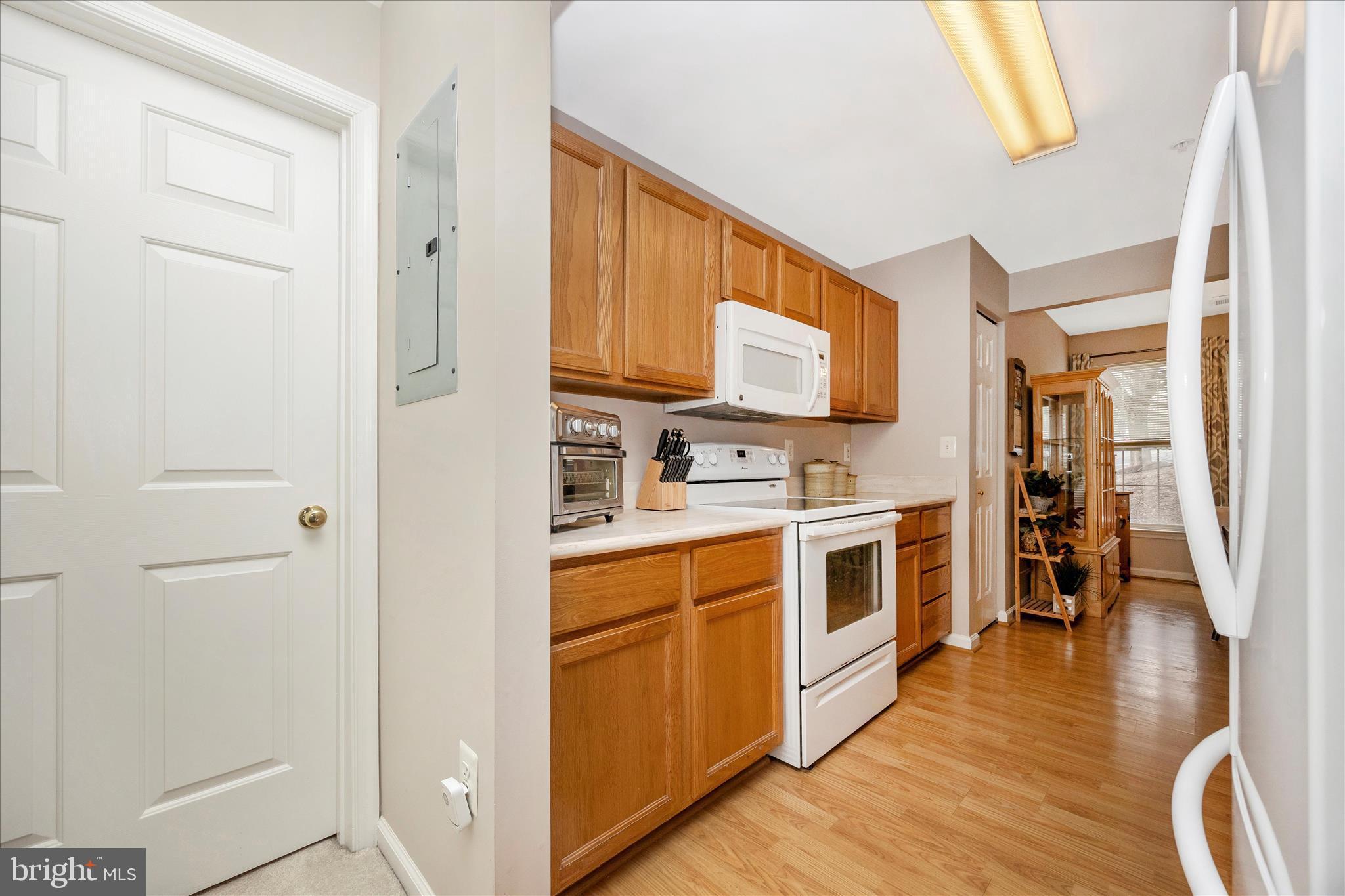 25900 Ridge Manor Drive, Unit 6000B Damascus, MD 20872 - Photo 18 of 39 a large kitchen with stainless steel appliances granite countertop a stove a sink and a refrigerator