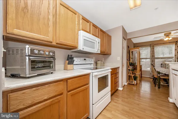 a kitchen with stainless steel appliances granite countertop a stove and white cabinets