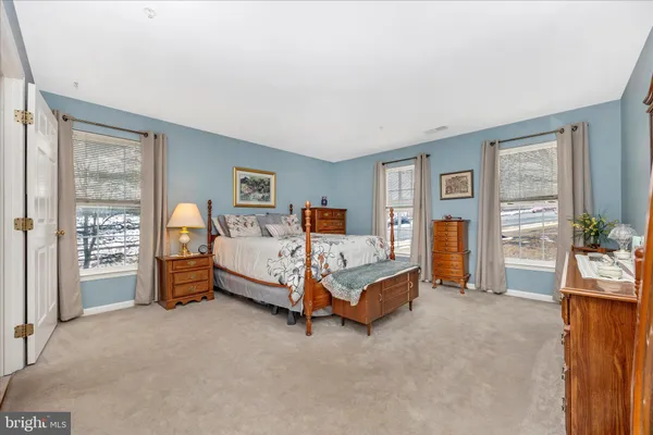 a bed room with a bed and a chair