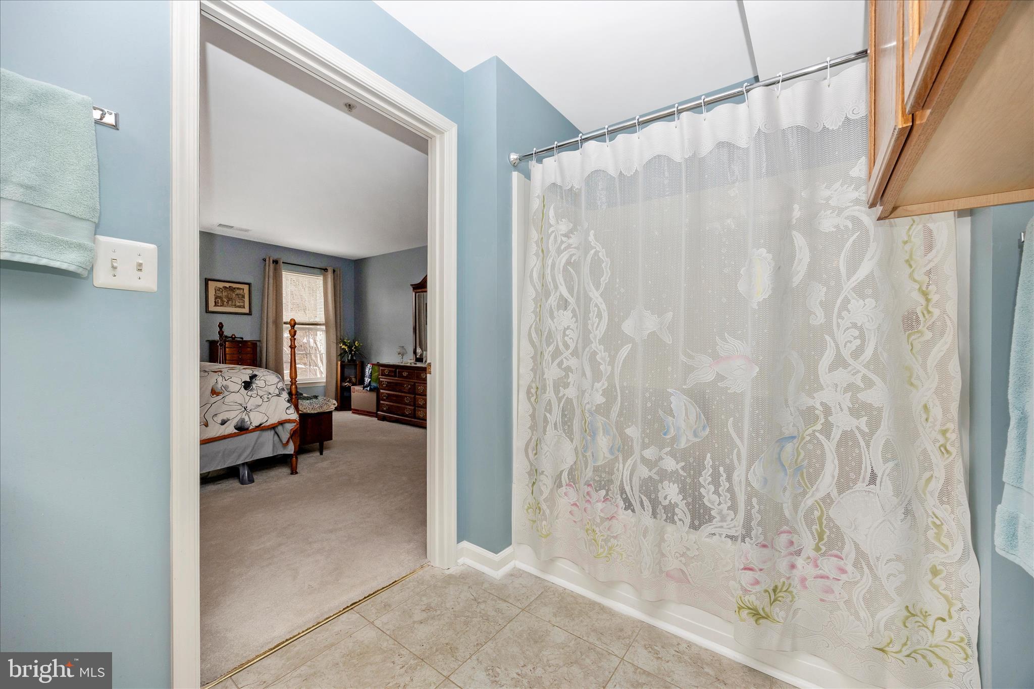 25900 Ridge Manor Drive, Unit 6000B Damascus, MD 20872 - Photo 31 of 39 a bedroom with a bed and a couch