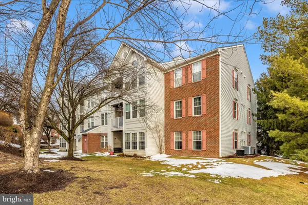 a front view of a building with a yard