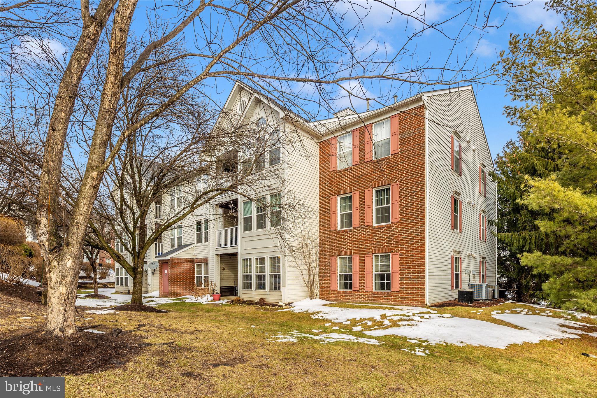 25900 Ridge Manor Drive, Unit 6000B Damascus, MD 20872 - Photo 33 of 39 a front view of a building with a yard