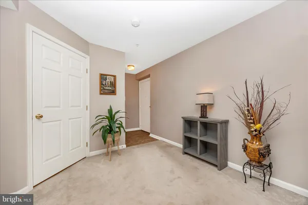 a view of a livingroom with furniture and a potted plant