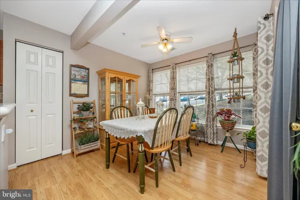 a view of a dining room with furniture window and wooden floor